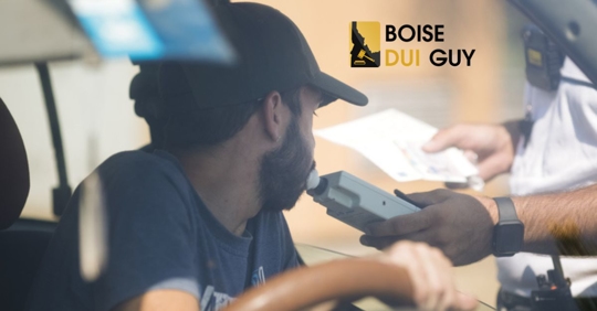 Police officer hands a breathalyser to a driver to test his alcohol level