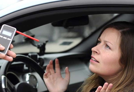 Woman in car with breathlyzer