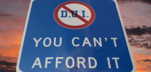 A sign that says, "DUI, You Can't Afford It".